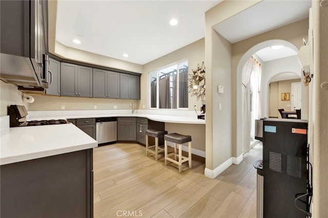 7021 Passons Blvd, Pico Rivera, CA 90660 - kitchen featuring dishwasher, white gas range oven, arched walkways, gray cabinetry, and plenty of natural light