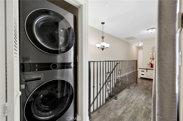7021 Passons Blvd, Pico Rivera, CA 90660 - laundry room featuring stacked washing machine and dryer, wood finished floors, and a chandelier