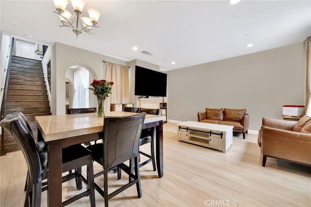 7021 Passons Blvd, Pico Rivera, CA 90660 - dining area featuring stairs, arched walkways, a chandelier, light wood-style flooring, and recessed lighting