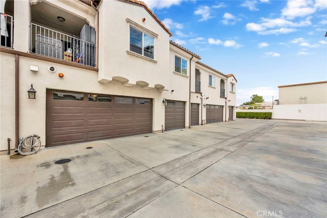 7021 Passons Blvd, Pico Rivera, CA 90660 - back of house with concrete driveway, an attached garage, stucco siding, and a tile roof