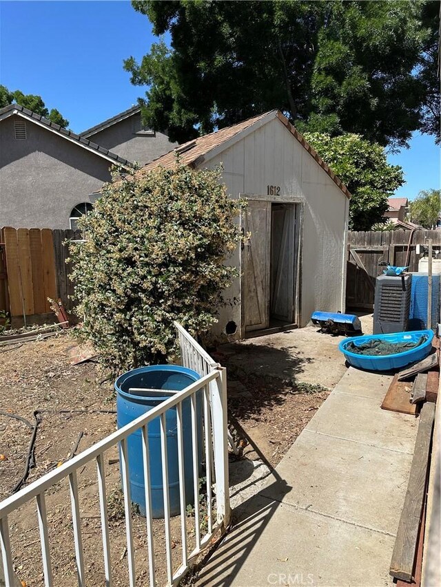 1612 Via Colabria, Gustine, CA 95322 - view of patio featuring an outbuilding