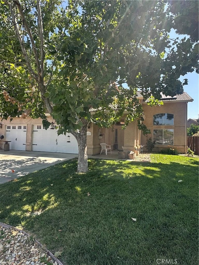 1612 Via Colabria, Gustine, CA 95322 - view of front of home featuring stucco siding, a front yard, a garage, and driveway
