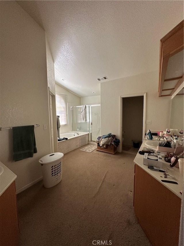 1612 Via Colabria, Gustine, CA 95322 - full bath with vanity, a shower stall, a bath, lofted ceiling, and a textured ceiling