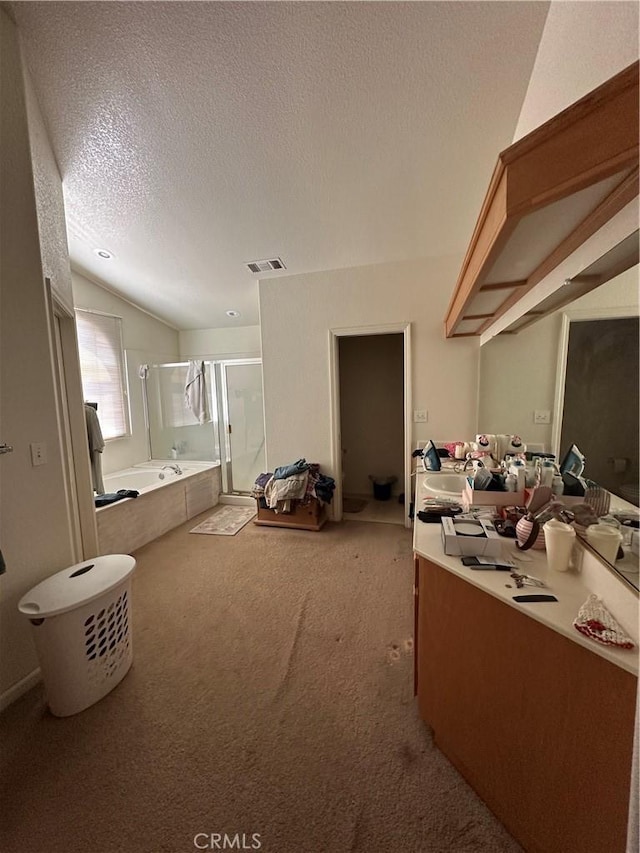 1612 Via Colabria, Gustine, CA 95322 - bathroom with a shower stall, a bath, double vanity, a textured ceiling, and vaulted ceiling