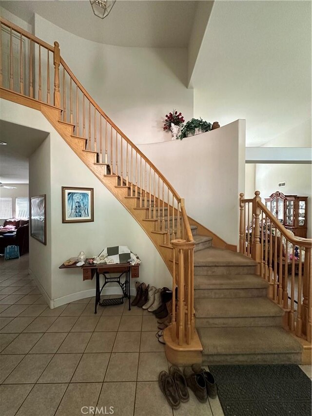 1612 Via Colabria, Gustine, CA 95322 - stairway with tile patterned flooring, a towering ceiling, and baseboards