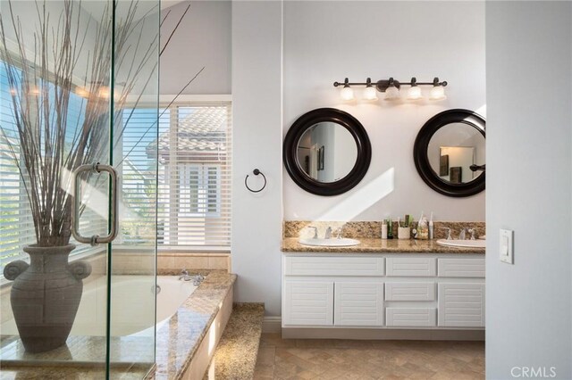 9534 Tivoli Cir, Cypress, CA 90630 - bathroom featuring double vanity, a garden tub, and an enclosed shower