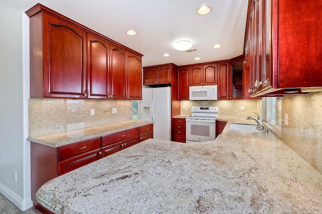 1160 Via Trieste, Chula Vista, CA 91911 - kitchen featuring white appliances, reddish brown cabinets, light stone counters, recessed lighting, and tasteful backsplash