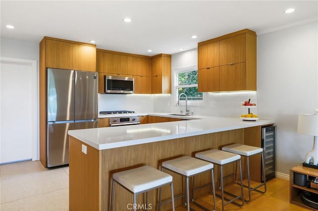 27642 Avenida Del Mesa, Rancho Palos Verdes, CA 90275 - kitchen with appliances with stainless steel finishes, a sink, beverage cooler, brown cabinets, and a peninsula