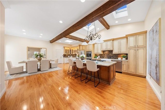 12 Rockrose Way, Irvine, CA 92612 - kitchen with a skylight, stainless steel appliances, a spacious island, a kitchen bar, and backsplash
