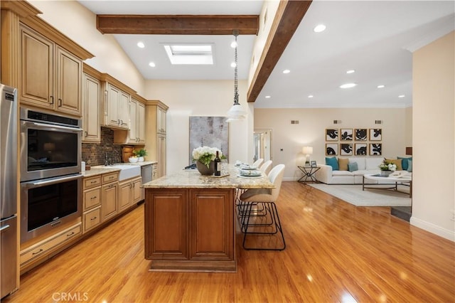 12 Rockrose Way, Irvine, CA 92612 - kitchen featuring appliances with stainless steel finishes, backsplash, a kitchen breakfast bar, light wood-style flooring, and beam ceiling