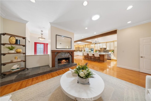 12 Rockrose Way, Irvine, CA 92612 - living room featuring crown molding, a high end fireplace, recessed lighting, light wood finished floors, and a chandelier