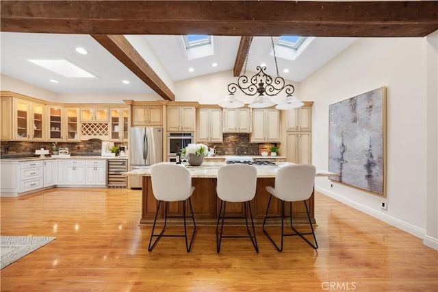 12 Rockrose Way, Irvine, CA 92612 - kitchen with a skylight, appliances with stainless steel finishes, wine cooler, tasteful backsplash, and a large island