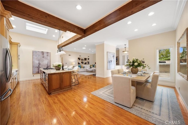 12 Rockrose Way, Irvine, CA 92612 - dining space with beam ceiling, light wood-style flooring, recessed lighting, baseboards, and a skylight