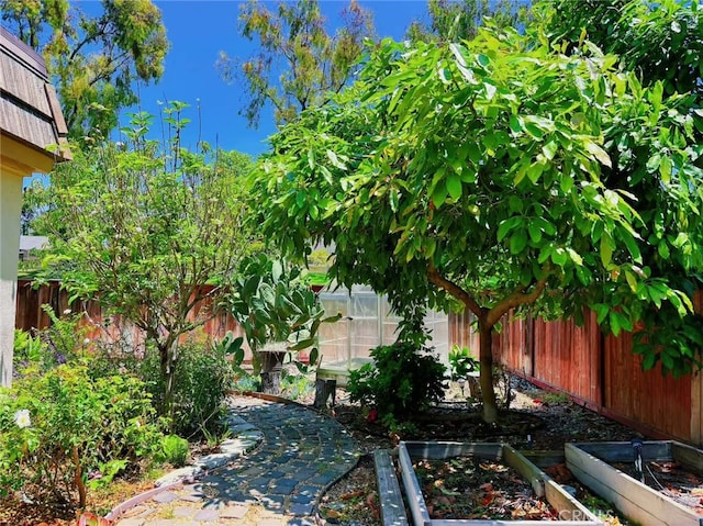 12 Rockrose Way, Irvine, CA 92612 - fenced backyard featuring a vegetable garden and a greenhouse