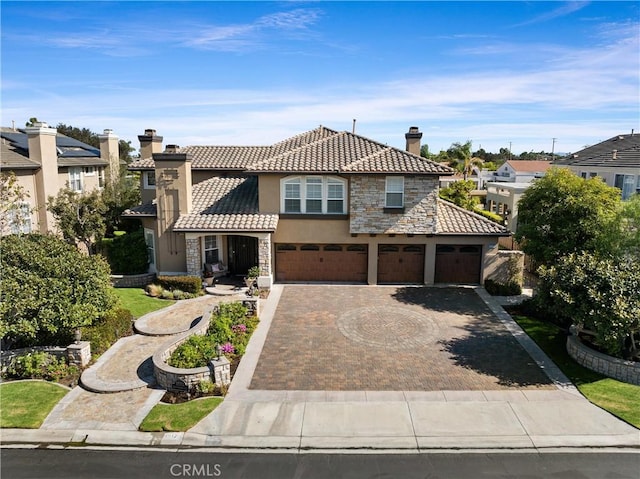 18912 Rockinghorse Ln, Huntington Beach, CA 92648 - view of front of home featuring stone siding, stucco siding, a chimney, a tiled roof, and driveway