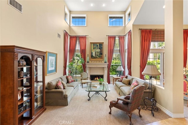 18912 Rockinghorse Ln, Huntington Beach, CA 92648 - living area with a towering ceiling, a warm lit fireplace, recessed lighting, and baseboards