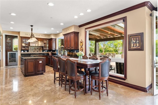18912 Rockinghorse Ln, Huntington Beach, CA 92648 - dining space featuring light marble finish flooring, recessed lighting, crown molding, baseboards, and beverage cooler