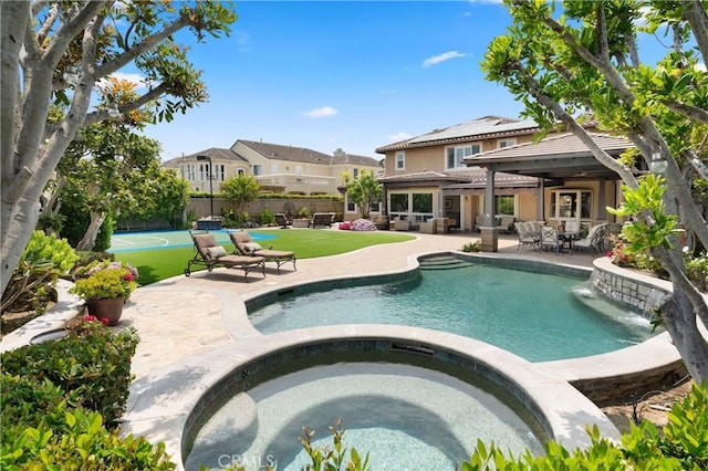 18912 Rockinghorse Ln, Huntington Beach, CA 92648 - view of swimming pool with a pool with connected hot tub, a patio, outdoor dining space, and a residential view