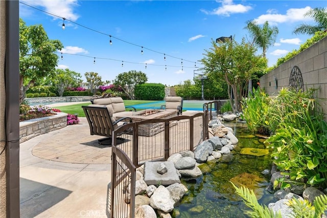 18912 Rockinghorse Ln, Huntington Beach, CA 92648 - view of patio featuring an outdoor living space with a fire pit and a garden pond
