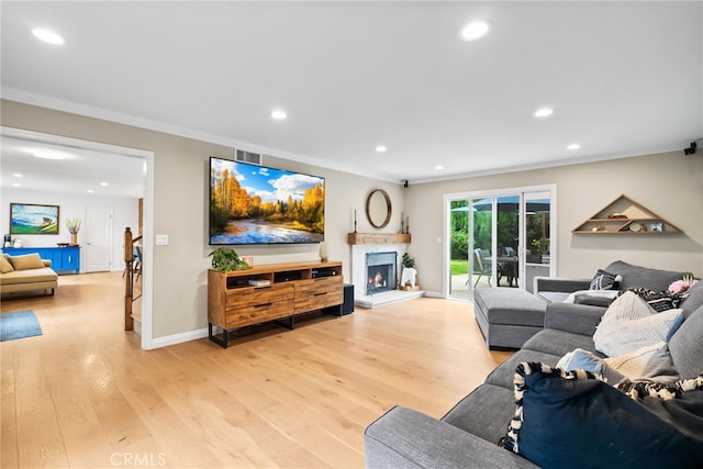 1161 Ravencrest Rd, North Tustin, CA 92705 - living area featuring recessed lighting, light wood finished floors, a warm lit fireplace, and crown molding