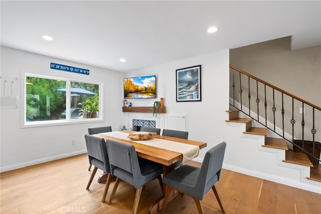 1161 Ravencrest Rd, North Tustin, CA 92705 - dining space with light wood-type flooring, stairway, recessed lighting, and a fireplace