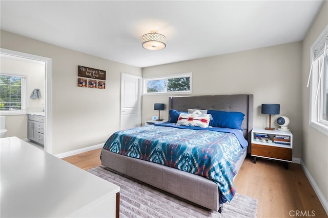 1161 Ravencrest Rd, North Tustin, CA 92705 - bedroom featuring light wood-style flooring, multiple windows, and connected bathroom