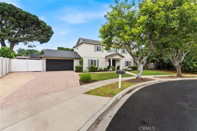 1161 Ravencrest Rd, North Tustin, CA 92705 - traditional-style house featuring stucco siding, an attached garage, and decorative driveway