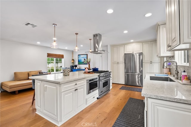 1161 Ravencrest Rd, North Tustin, CA 92705 - kitchen with high end appliances, wall chimney exhaust hood, recessed lighting, decorative backsplash, and open floor plan