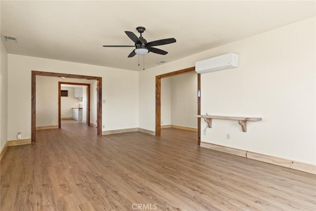 490 Vilas Rd, Chico, CA 95973 - unfurnished room featuring an AC wall unit, light wood-style flooring, ceiling fan, and baseboards