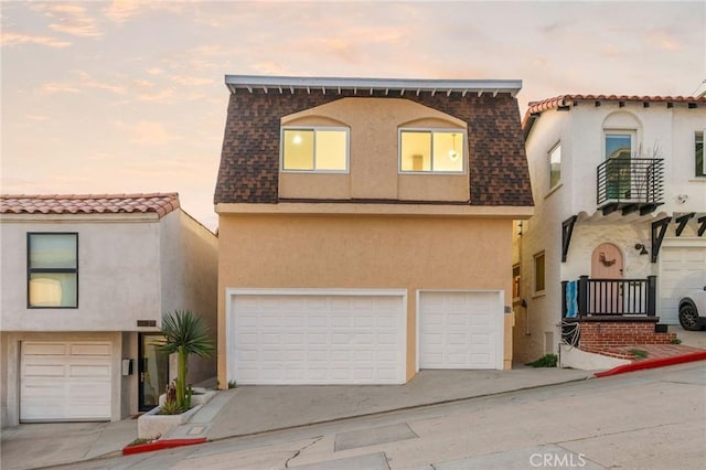 217 43rd St, Manhattan Beach, CA 90266 - view of front of home featuring an attached garage, stucco siding, and concrete driveway