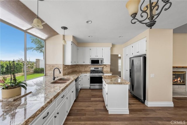 24952 Eaton Ln, Laguna Niguel, CA 92677 - kitchen featuring stainless steel appliances, plenty of natural light, light stone countertops, decorative backsplash, and recessed lighting