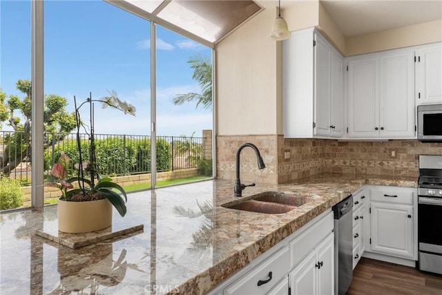 24952 Eaton Ln, Laguna Niguel, CA 92677 - kitchen with appliances with stainless steel finishes, backsplash, and white cabinets