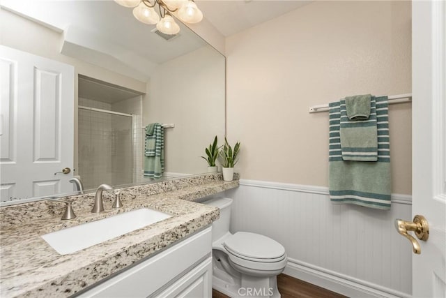 24952 Eaton Ln, Laguna Niguel, CA 92677 - full bath with vanity, wainscoting, a shower, and wood finished floors