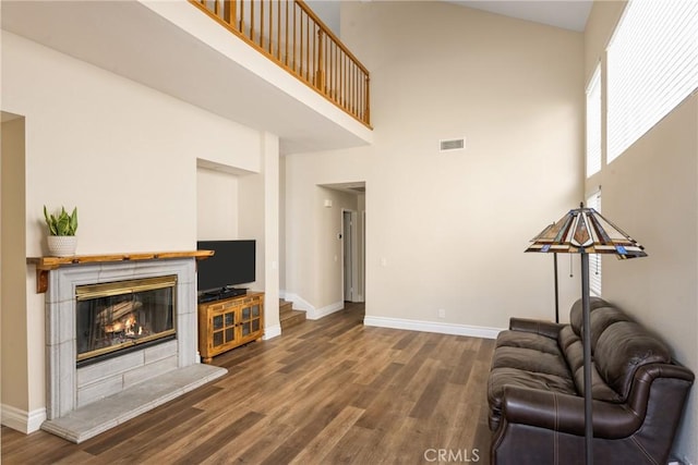 24952 Eaton Ln, Laguna Niguel, CA 92677 - living room featuring a high ceiling, wood finished floors, and a fireplace