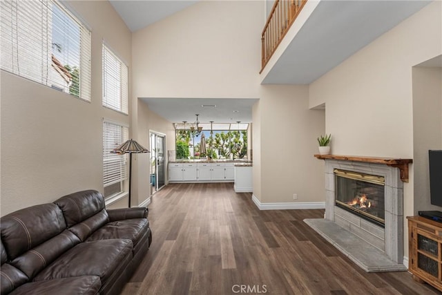 24952 Eaton Ln, Laguna Niguel, CA 92677 - living area featuring a towering ceiling, dark wood-style flooring, and a fireplace