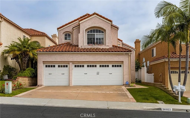 24952 Eaton Ln, Laguna Niguel, CA 92677 - mediterranean / spanish home with driveway, a tiled roof, and stucco siding