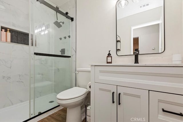 22554 Pico St, Grand Terrace, CA 92313 - full bath featuring toilet, a marble finish shower, vanity, and wood finished floors