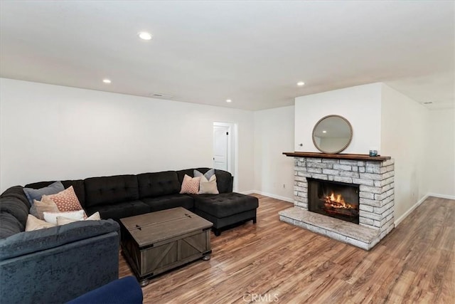 22554 Pico St, Grand Terrace, CA 92313 - living area featuring wood finished floors, baseboards, a warm lit fireplace, and recessed lighting