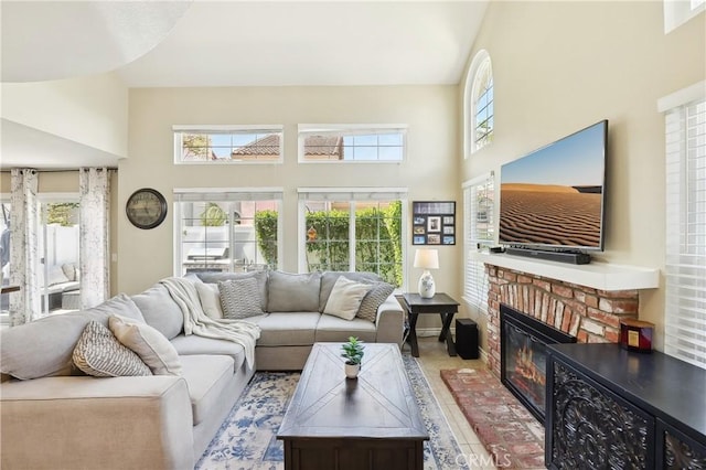 1 Buttercup Unit 42, Rancho Santa Margarita, CA 92688 - living area featuring a brick fireplace and a towering ceiling