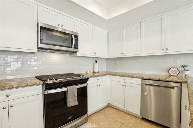 1 Buttercup Unit 42, Rancho Santa Margarita, CA 92688 - kitchen with appliances with stainless steel finishes, white cabinetry, decorative backsplash, and light stone counters