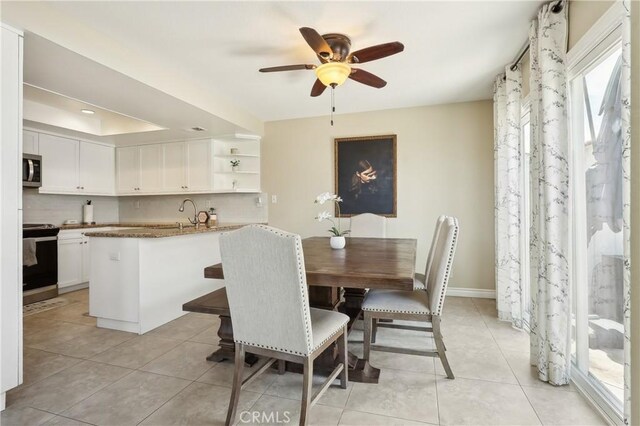 1 Buttercup Unit 42, Rancho Santa Margarita, CA 92688 - dining space featuring a ceiling fan, light tile patterned floors, a tray ceiling, and baseboards