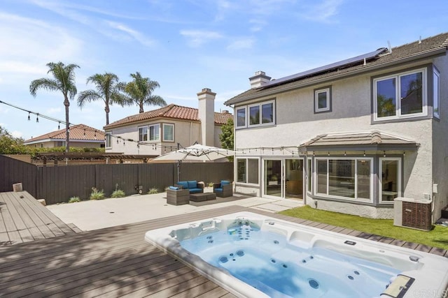 5233 Belardo Dr, San Diego, CA 92124 - back of property with a wooden deck, stucco siding, an outdoor living space, solar panels, and a chimney