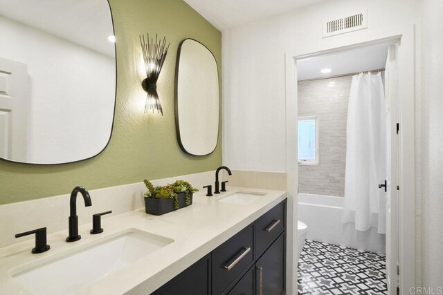 5233 Belardo Dr, San Diego, CA 92124 - bathroom featuring double vanity and shower / tub combo with curtain
