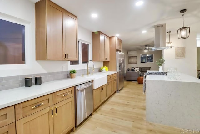 3776 Enero Ct, San Diego, CA 92154 - kitchen with appliances with stainless steel finishes, island range hood, light wood-style floors, a sink, and open floor plan
