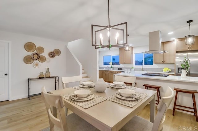 3776 Enero Ct, San Diego, CA 92154 - dining space with light wood-style floors and a chandelier