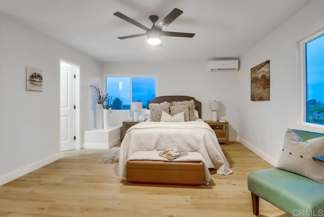 3776 Enero Ct, San Diego, CA 92154 - bedroom featuring a wall unit AC, baseboards, light wood-type flooring, ceiling fan, and multiple windows