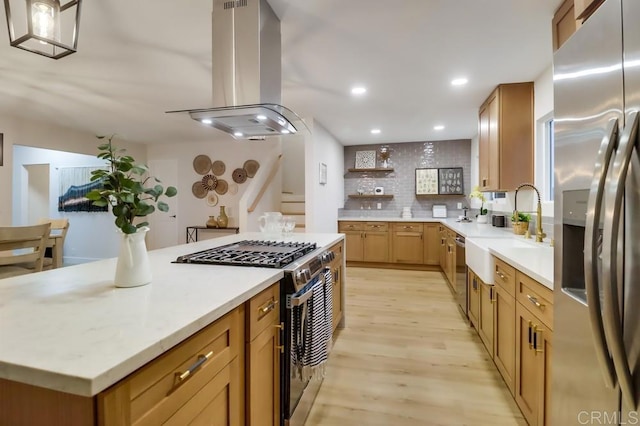 3776 Enero Ct, San Diego, CA 92154 - kitchen featuring stainless steel appliances, island range hood, light wood-style flooring, light countertops, and tasteful backsplash