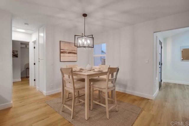 3776 Enero Ct, San Diego, CA 92154 - dining space with a chandelier, light wood-style floors, and baseboards