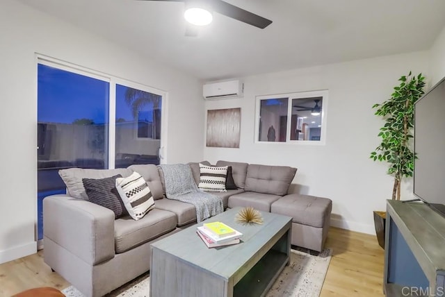 3776 Enero Ct, San Diego, CA 92154 - living area featuring a wall unit AC, a ceiling fan, light wood-style flooring, and baseboards