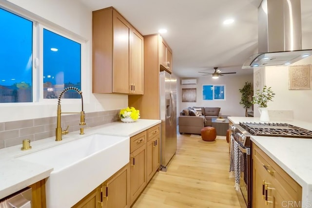 3776 Enero Ct, San Diego, CA 92154 - kitchen featuring island exhaust hood, stainless steel appliances, a sink, open floor plan, and light wood-style flooring